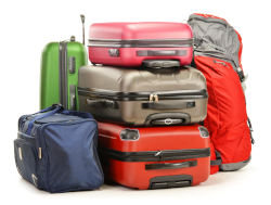 Photo of assorted suitcases and duffels on a white background