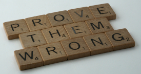 Scrabble tiles spelling PROVE THEM WRONG