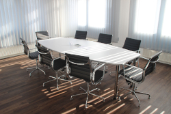 Photo of an empty conference room with table and chairs
