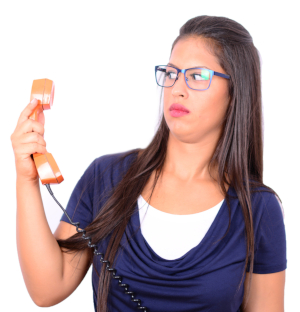 Photo of a woman holding an old-style landline phone receiver out in front of her and looking very confused.