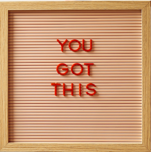 A sign, framed in light-colored wood, reading YOU GOT THIS in red letters.