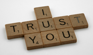 Wooden scrabble letters spelling out "I trust you"