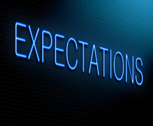 Neon-blue letters placed diagonally on a blue-to-black gradient background; reads EXPECTATIONS